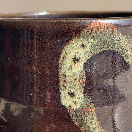 Close-up of a ceramic cup with a textured surface