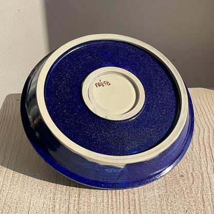 Blue ceramic plate with a textured surface on a wooden surface