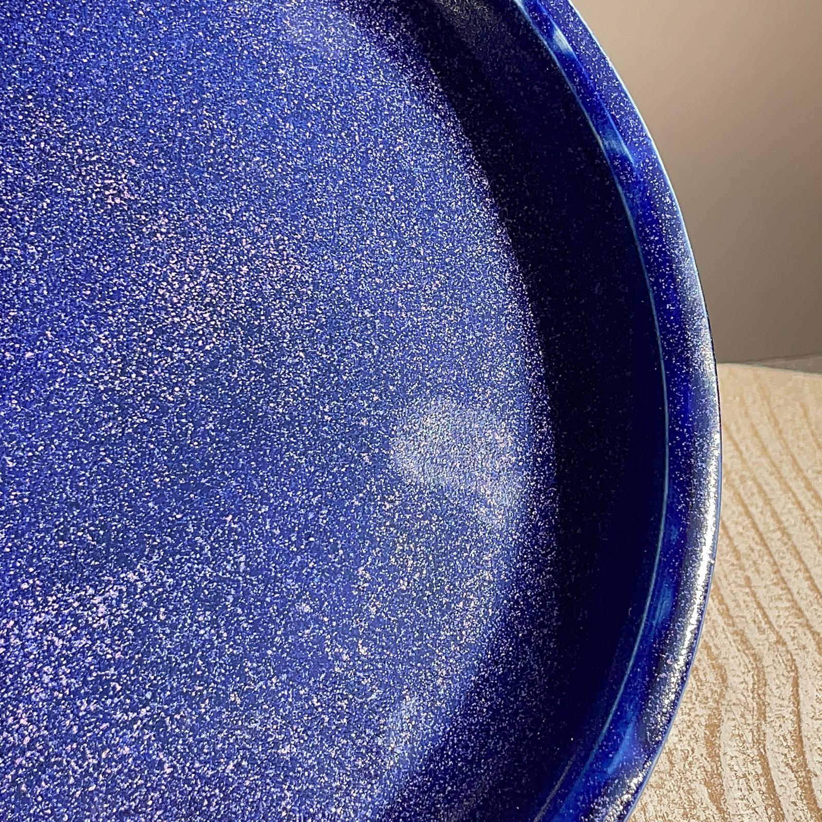 Close-up of a blue speckled plate on a wooden surface