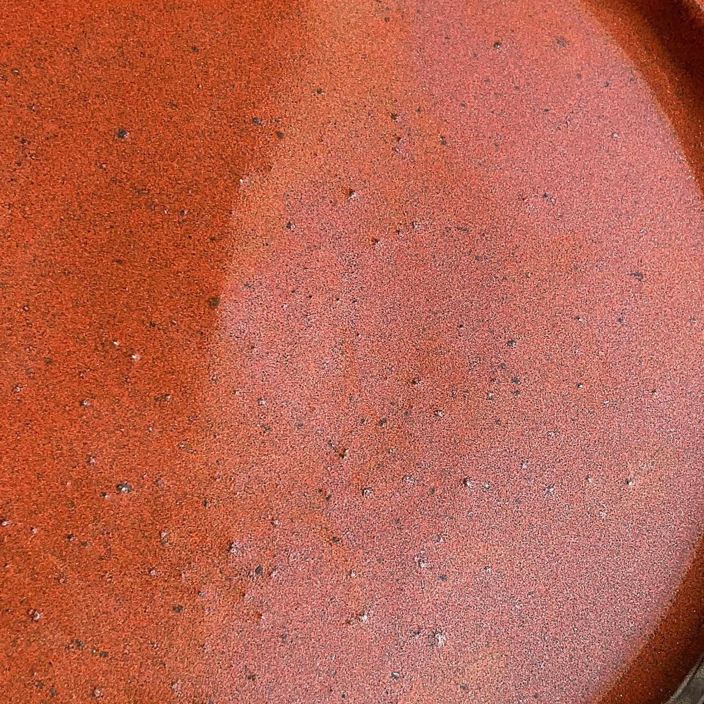 Close-up of a ceramic plate with a speckled glaze pattern