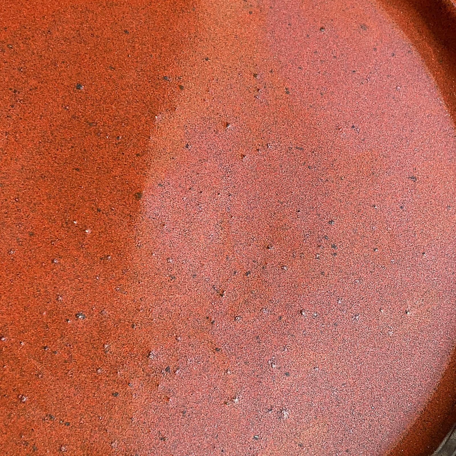 Close-up of a ceramic plate with a speckled glaze pattern