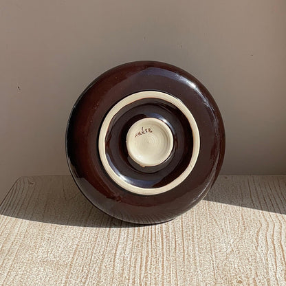 Brown ceramic plate on a wooden surface