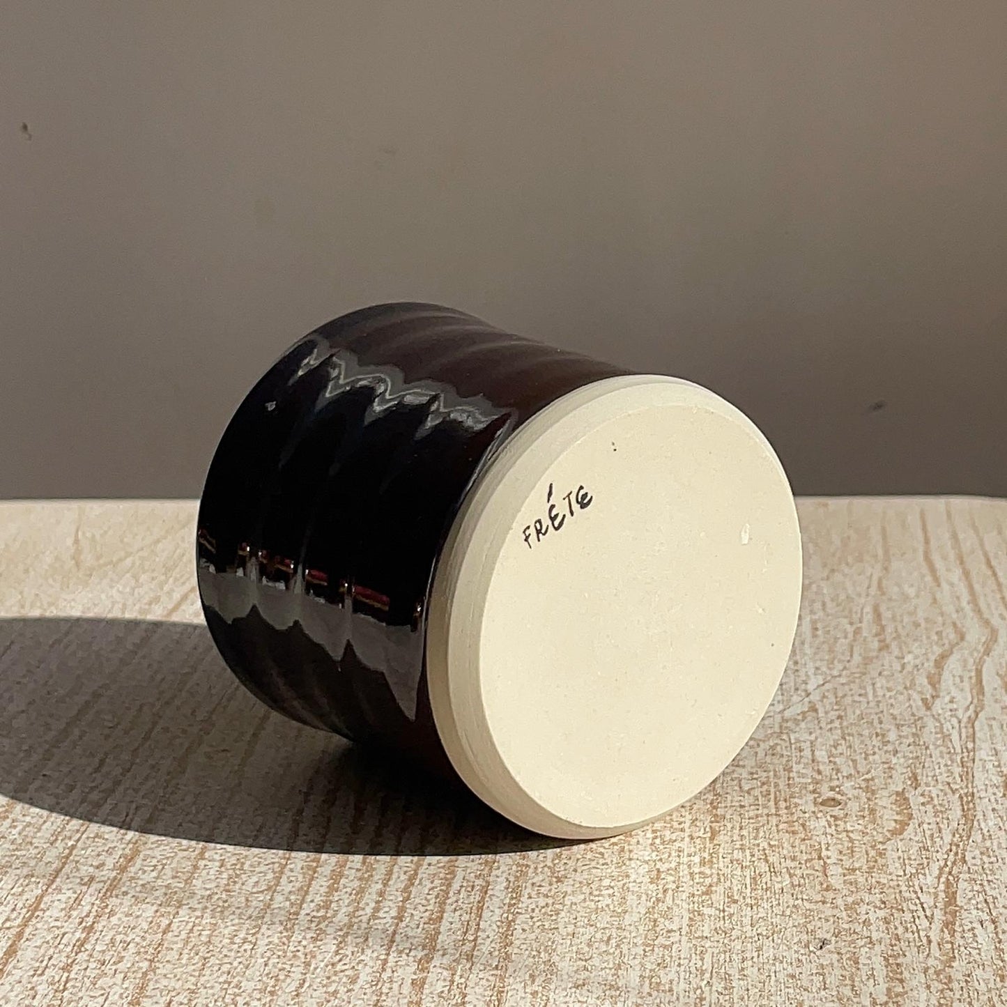 cup upside down in a textured surface with a neutral background