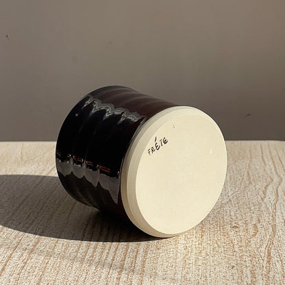 cup upside down in a textured surface with a neutral background