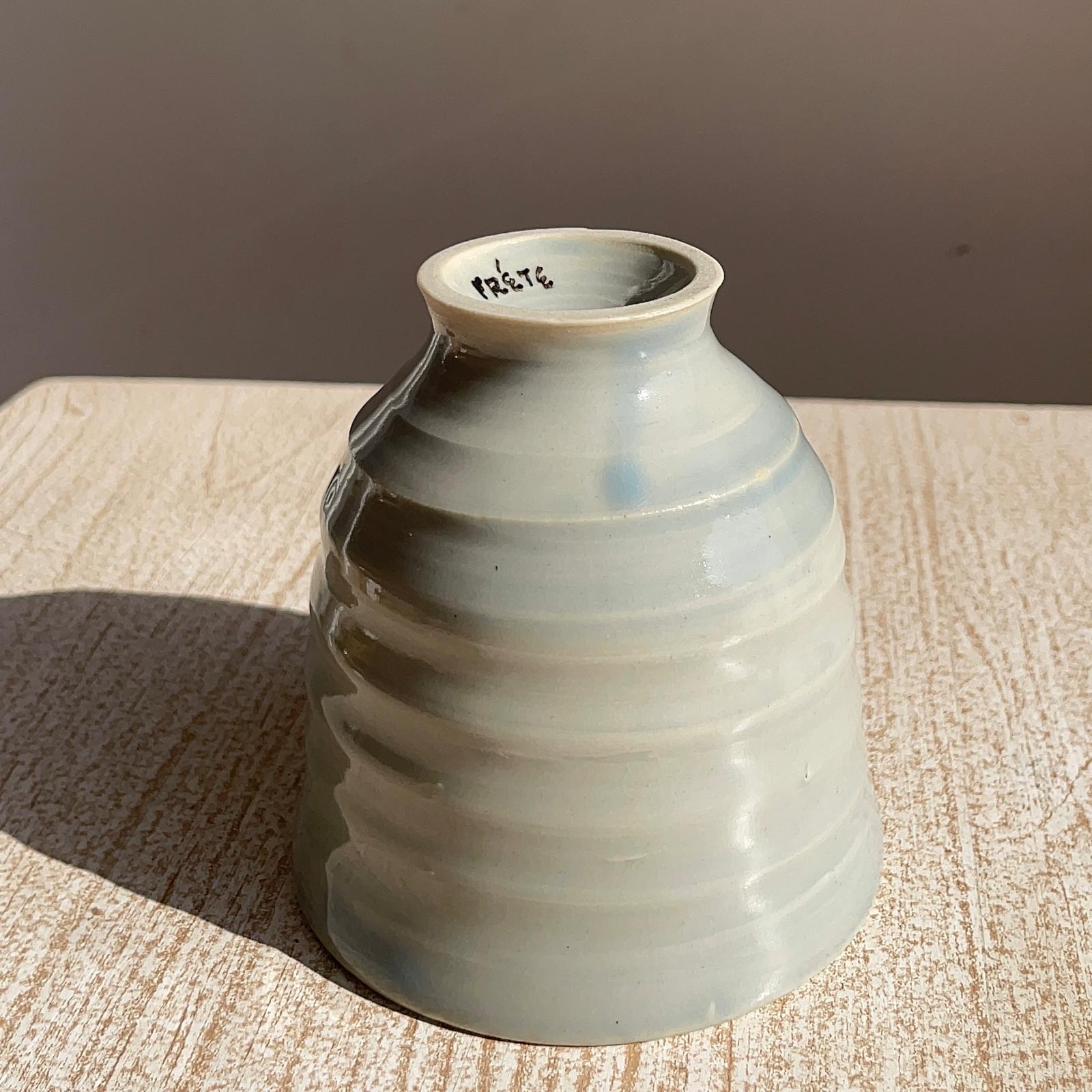 Ceramic cup with textured surface on a wooden surface