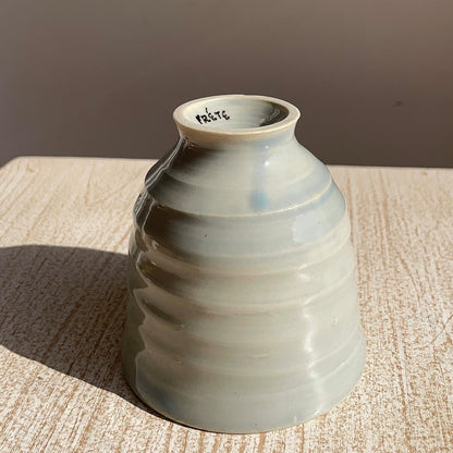 Ceramic cup with textured surface on a wooden surface
