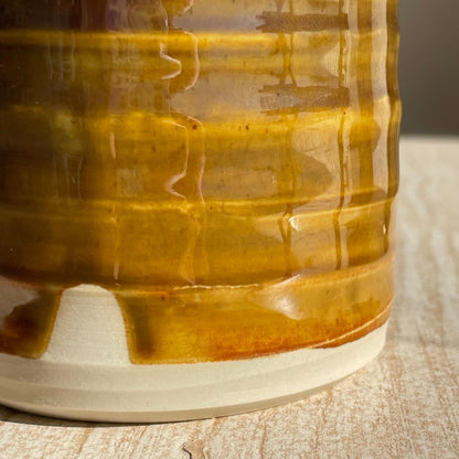 Close-up of a ceramic cup with a textured surface on a wooden surface