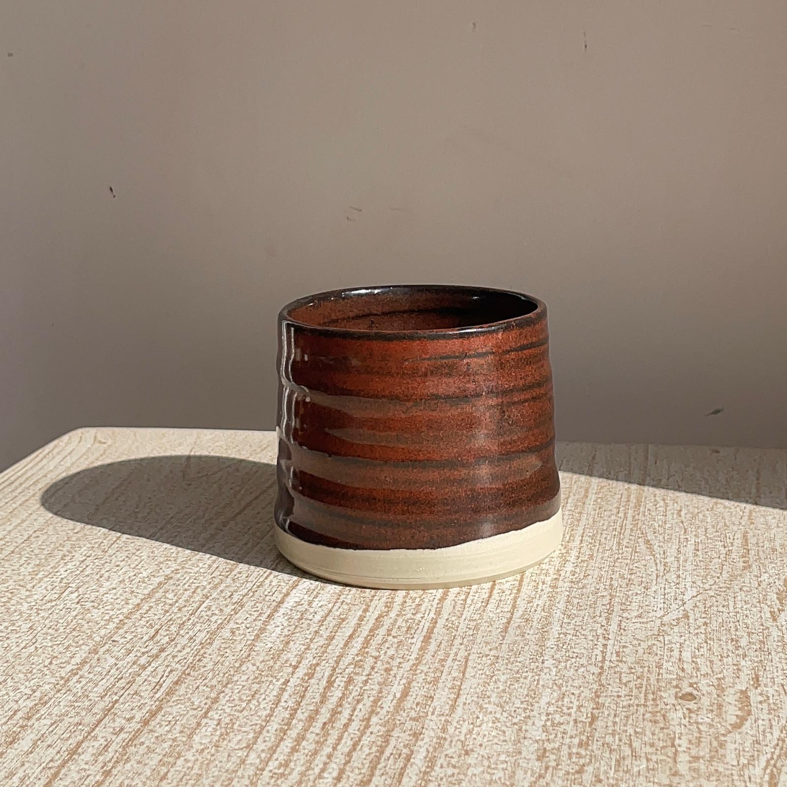 red cup on a textured surface with a neutral background