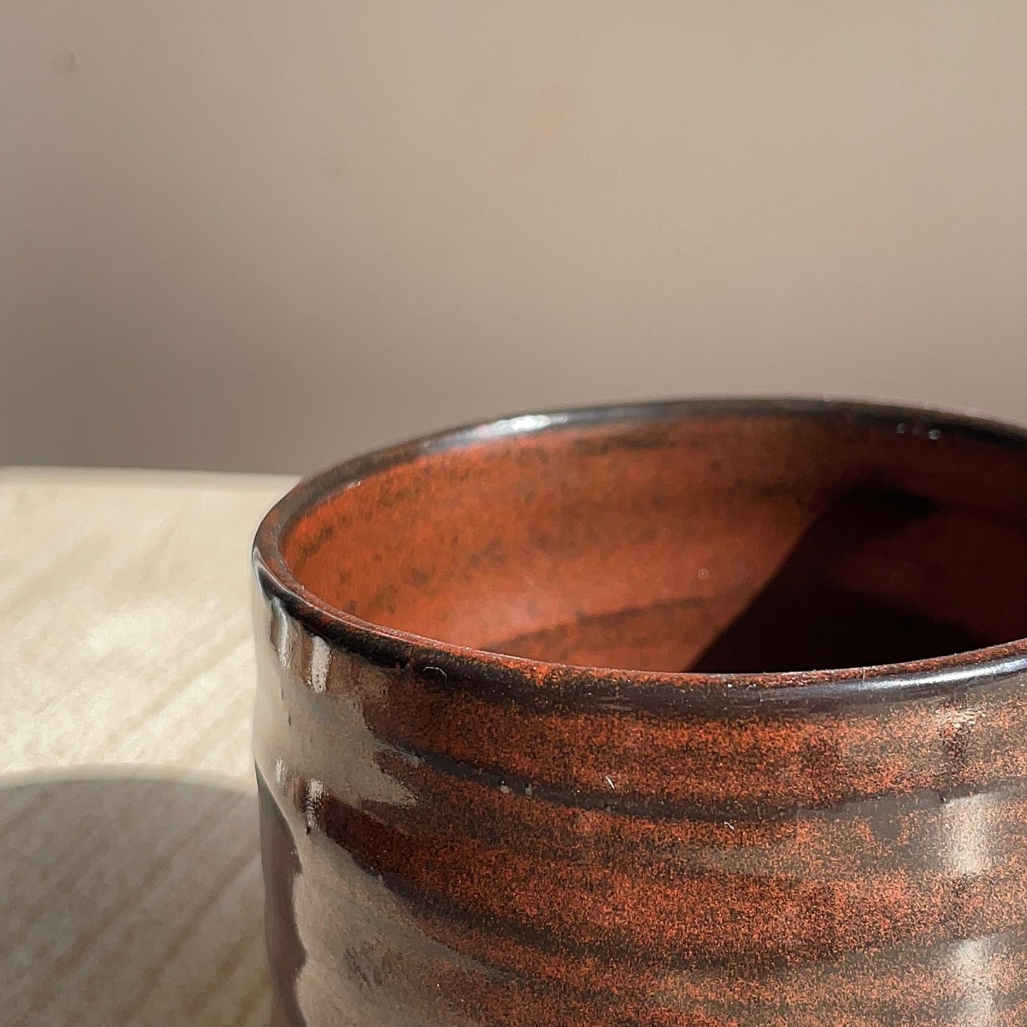 Close-up of a red cup with a textured surface.