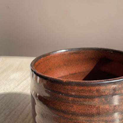 Close-up of a red cup with a textured surface.
