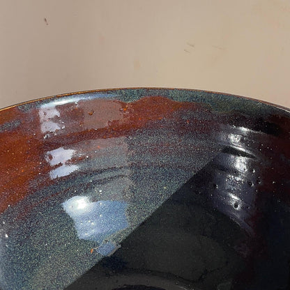 Close-up of a ceramic bowl with a glossy finish on a beige background