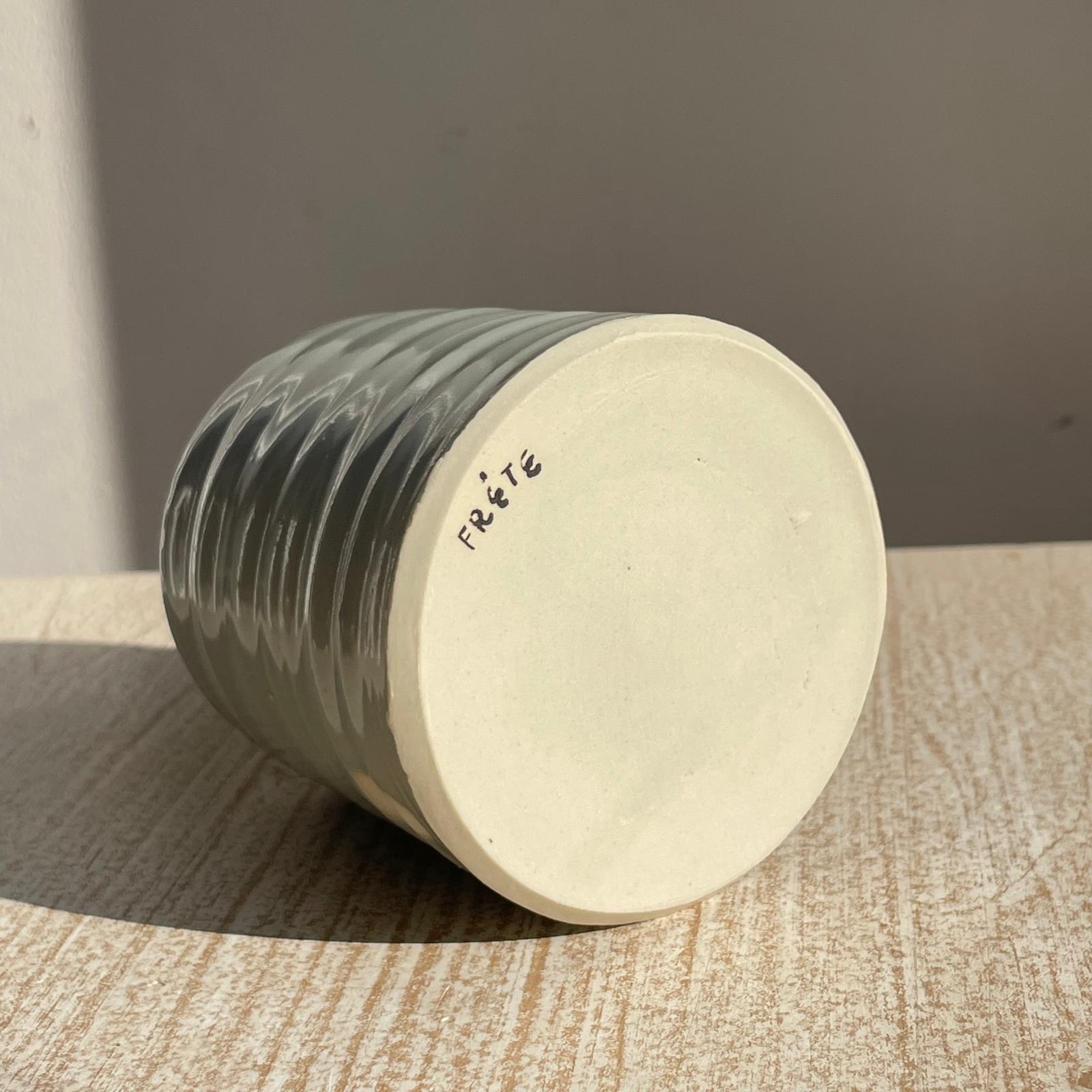 cup with textured surface on a wooden surface