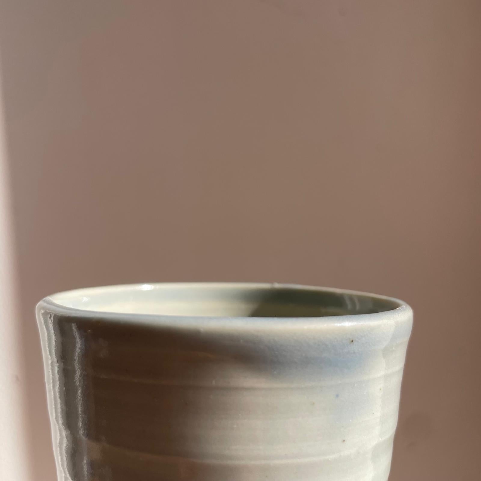 Ceramic cup with a textured surface on a plain background